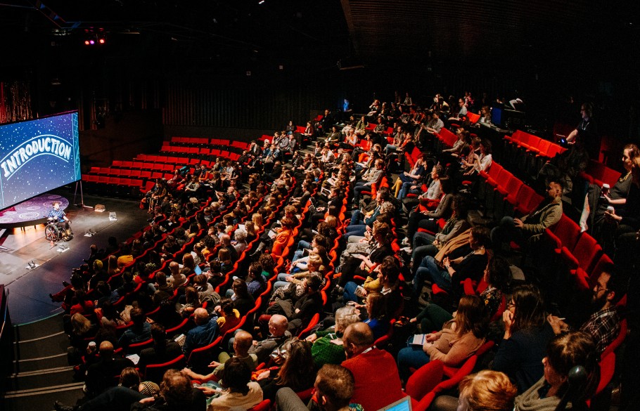 Participants of IETM Hull in a venue with red seats facing a stage